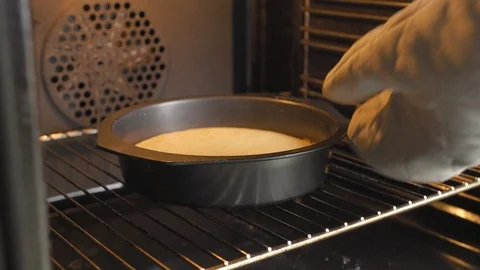 Take out a flan case from the oven. Stock Footage 94036101