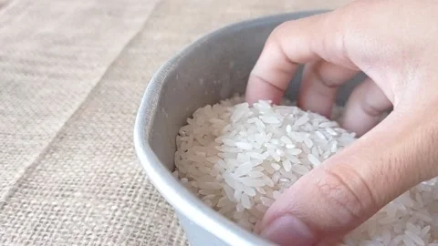 Take out a hand of rice from a tiny container Stock Footage 145622525