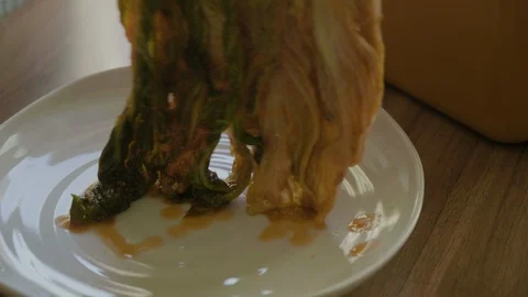 Take out the kimchi and put it on a white plate. Stock Footage 113897983