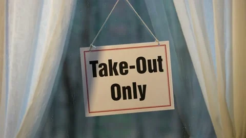 Take Out Only sign gently swinging in the window of store front display in Stock Footage 143145863
