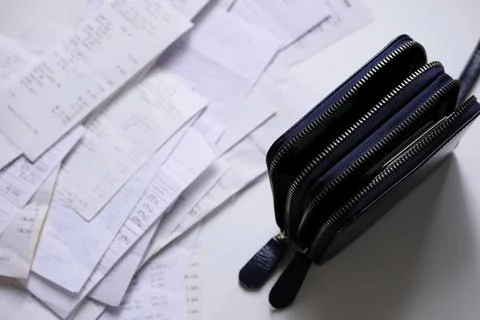 Take out a stack of payment receipts from the wallet 스톡 사진