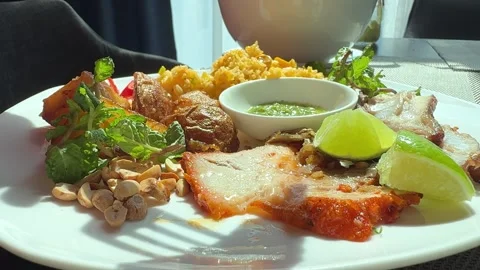 Take a piece of fatty pork with a fork and dip it into the sauce Stock Footage 309447962