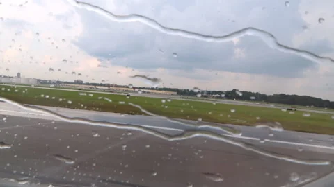 Take off of a plane under the rain Stock Footage 159128258