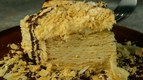 Take of puff appetizing Napoleon cake one slice cut with metal fork. Stock Footage 131850269