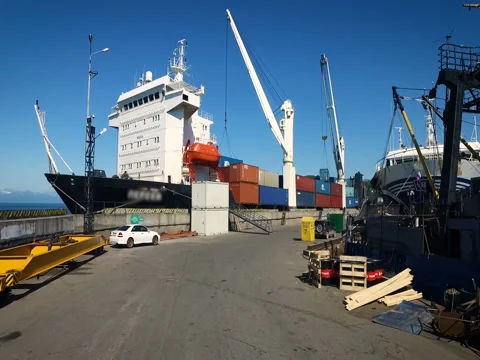 Take-off of the quadcopter from the port. Views on cargo vessels with containers Video stock 84744581