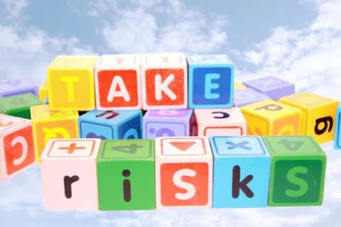 Take risks in colored play blocks Stock Photos