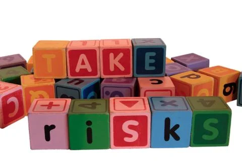 Take risks in multi colored play blocks Stock Photos