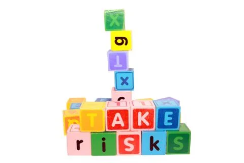 Take risks in play letter blocks Stock Photos