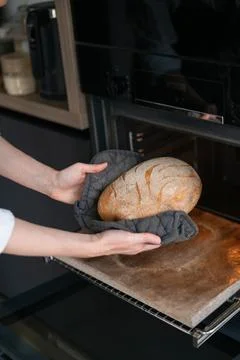 Take rye bread out of the oven Stock Photos