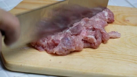 Take a sharp knife to chop pork , minced pork on wooden chopping board , prep Stock Footage 89294704