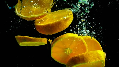 Take a slow motion of dropping oranges into a small water tank. 스톡 동영상 145349998