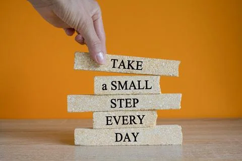 Take a small step every day symbol. Brick blocks with words Foto stock