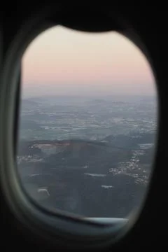 Take off at sunset time seen through the airplane window Stock Photos