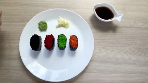 Take sushi with his hands and dunk in soy sauce Stock Footage 132335247