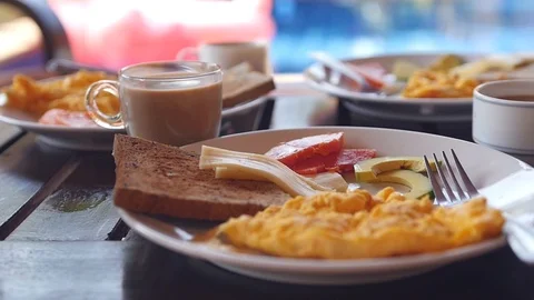 Take tasty invigorating coffee from the table with a delicious breakfast. Slow Stock Footage 88400066