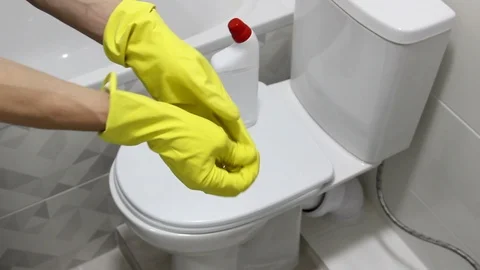 Take off yellow gloves, finished cleaning the bathroom Stock Footage 127981712