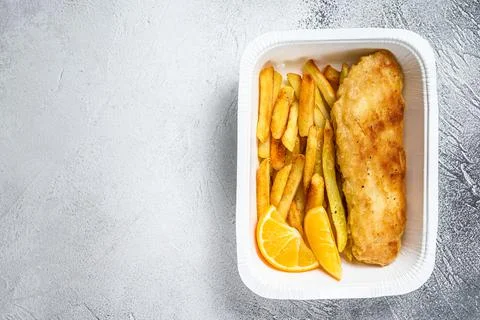 Takeaway box Fish and chips dish with french fries. White background. Top view Stock Photos
