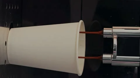 Takeaway coffee. Pouring coffee stream from machine in paper cup. Making black Stock Footage 232796019