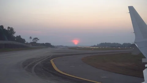 Takeoff from the airport. View from the window of the aircraft, sunset, sky. Video stock 106966604