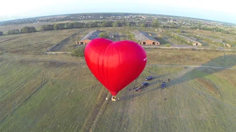 Takeoff hot air balloon in the shape of heart. Aerial view Stock-Footage 41717623