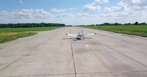 Takeoff of an old plane, down the runway, beautiful summer landscape, sun green Video stock 138035290