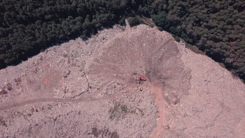 Takeoff over a garbage dump, boomerang effect, machinery works and people equal Stock Footage 138089841