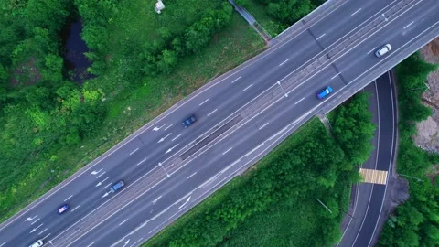 Takeoff over the highway. A highway in the middle of a green forest. Stock Footage 204011005