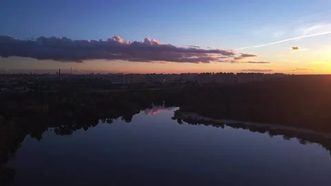 Takeoff over the lake during sunset overlooking the city with beautiful clouds Stock Footage 141497726