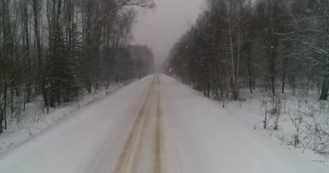 Takeoff over the winter road, with active snowfall Stock Footage 147678307