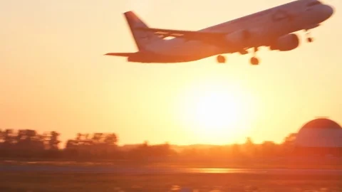 Takeoff of plane at the airport on the Sunset Stock Footage 78360978