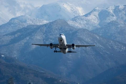Takeoff with Stunning Mountain Backdrop. 스톡 사진
