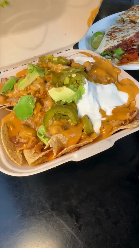 Takeout Box Next to Fresh Quesadilla Plate Stock Footage 323875997