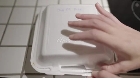 Takeout fried rice box opened on kitchen counter top Stock Footage 306886405