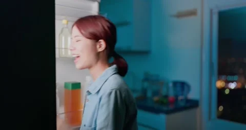 Takes apple from refrigerator Stock Footage 157411587