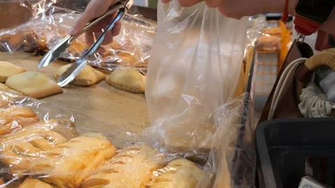 Takes fresh bun from the bakery. Stock Footage 282394609