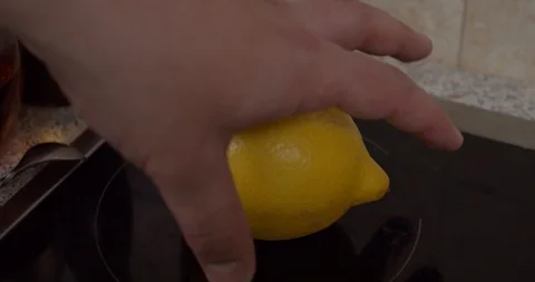 Takes a lemon and cuts it Stock Footage 130051949