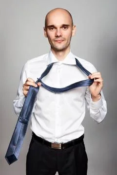 Takes off a Necktie Photos