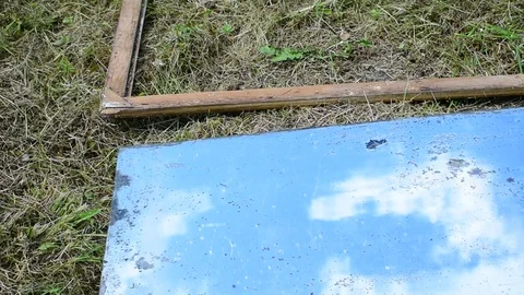 Takes out an old mirror from a frame Stock Footage 117111990