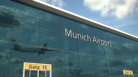 Taking off airplane reflecting in the modern windows with Munich Airport text Stock Footage 153800982