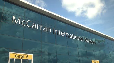 Taking off airplane reflecting in the modern windows with McCarran International Ilustración de archivo
