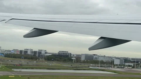 Taking off by airplane. View from plane illuminator on field, trees, houses. Stock Footage 163904598