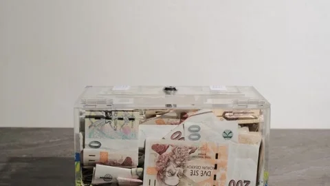Taking and giving Charity in nominal 100 Euro banknotes to a transparent donatio Stock Footage 274622310