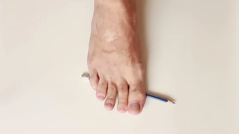 Taking and putting a pencil by foot Vídeos de archivo 79343749