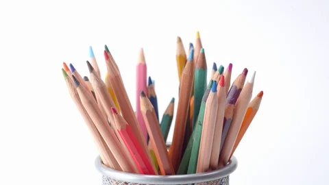 Taking and returning colouring pencils against a white backdrop Stock Footage 115669090