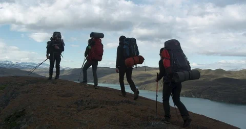 Taking off backpacks during guided expedition Stock Footage 90080099
