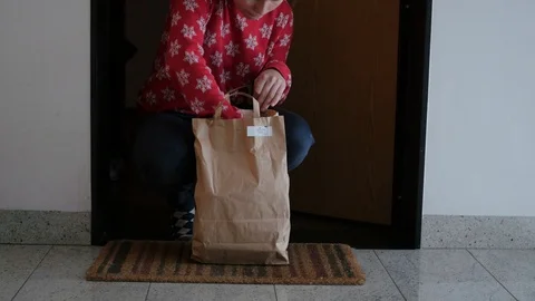 Taking bag with box diet from under the door Stock Footage 102130471