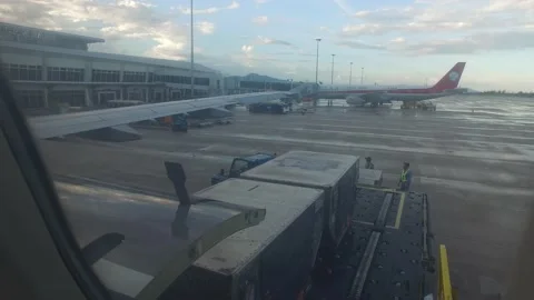 Taking baggage out of the plane at Cam Ranh Cam Ranh international airport Stock Footage 130917003