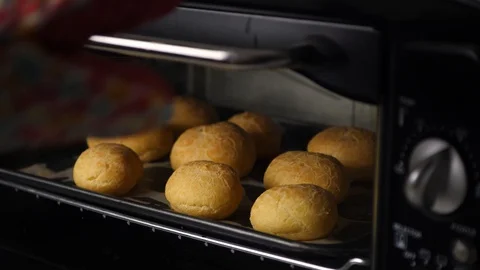 Taking baked bread out of small oven at home, 4K Stock Footage 128412474