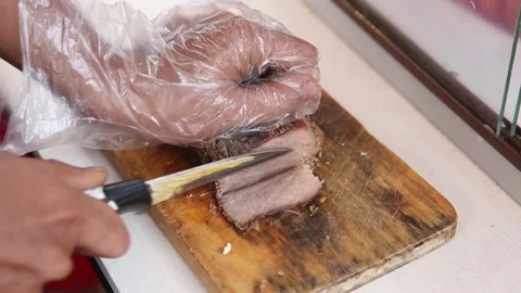 Taking beef and slicing the beef for soto Stock Footage 273041602