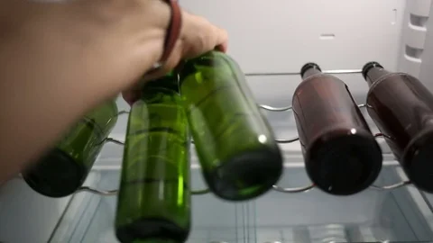 Taking beer bottles from the fridge Stock Footage 82862532
